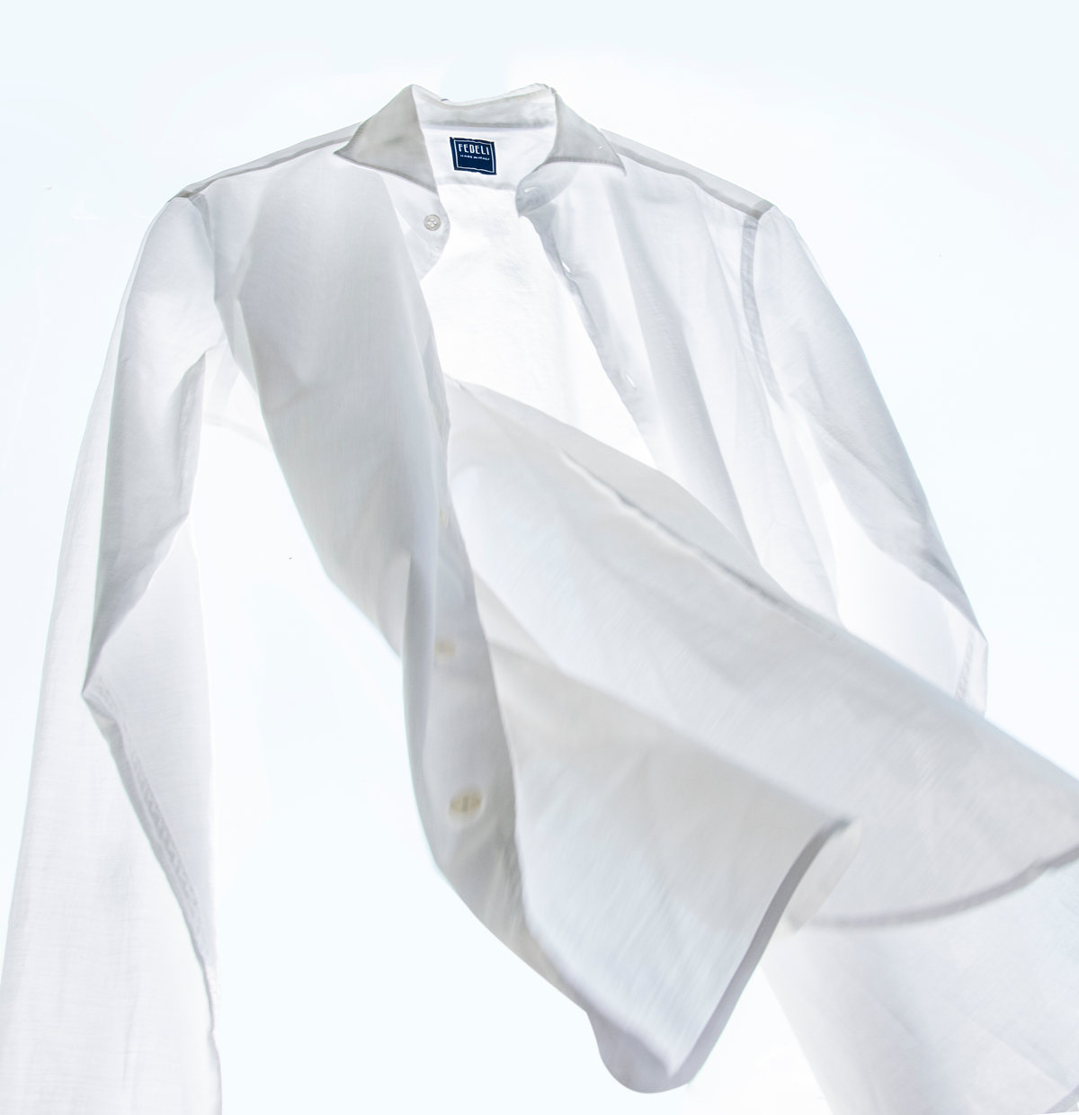 Camisa blanca en movimiento sobre fondo blanco