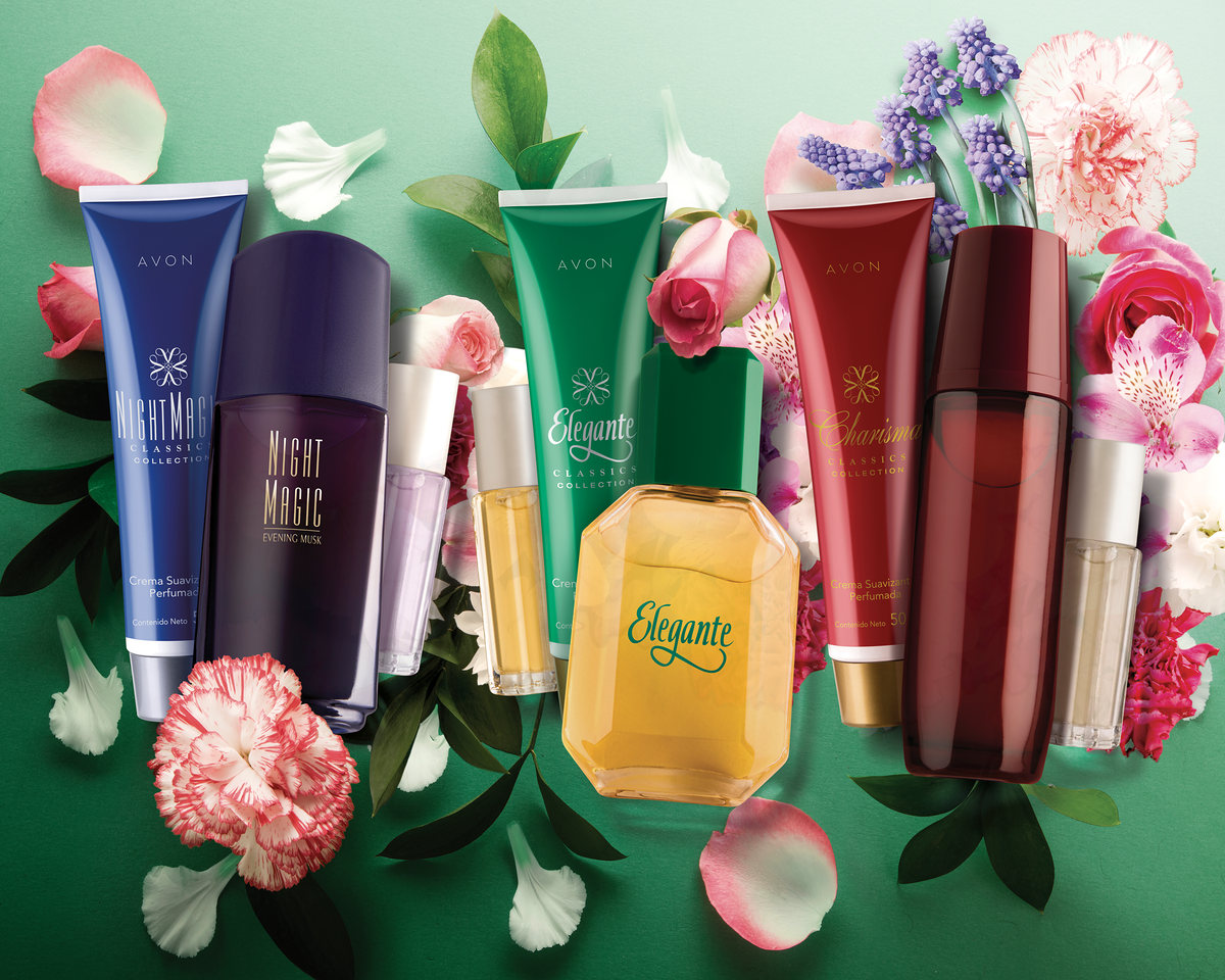 Fragrances and creams surrounded by carnations and petals on green