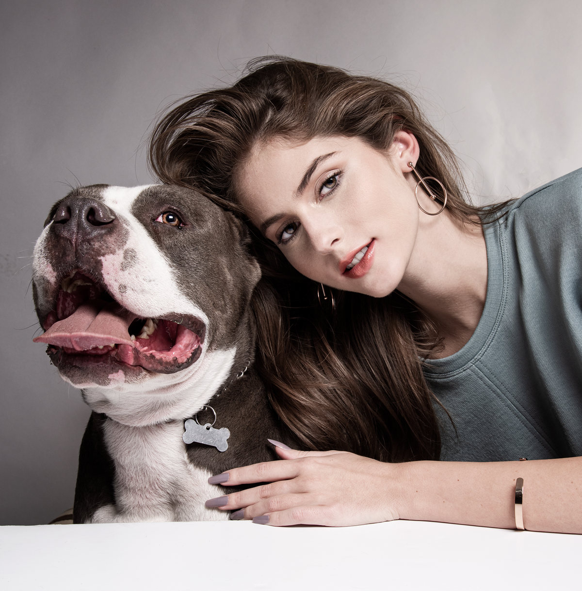 Model hugging a smiling pit bull