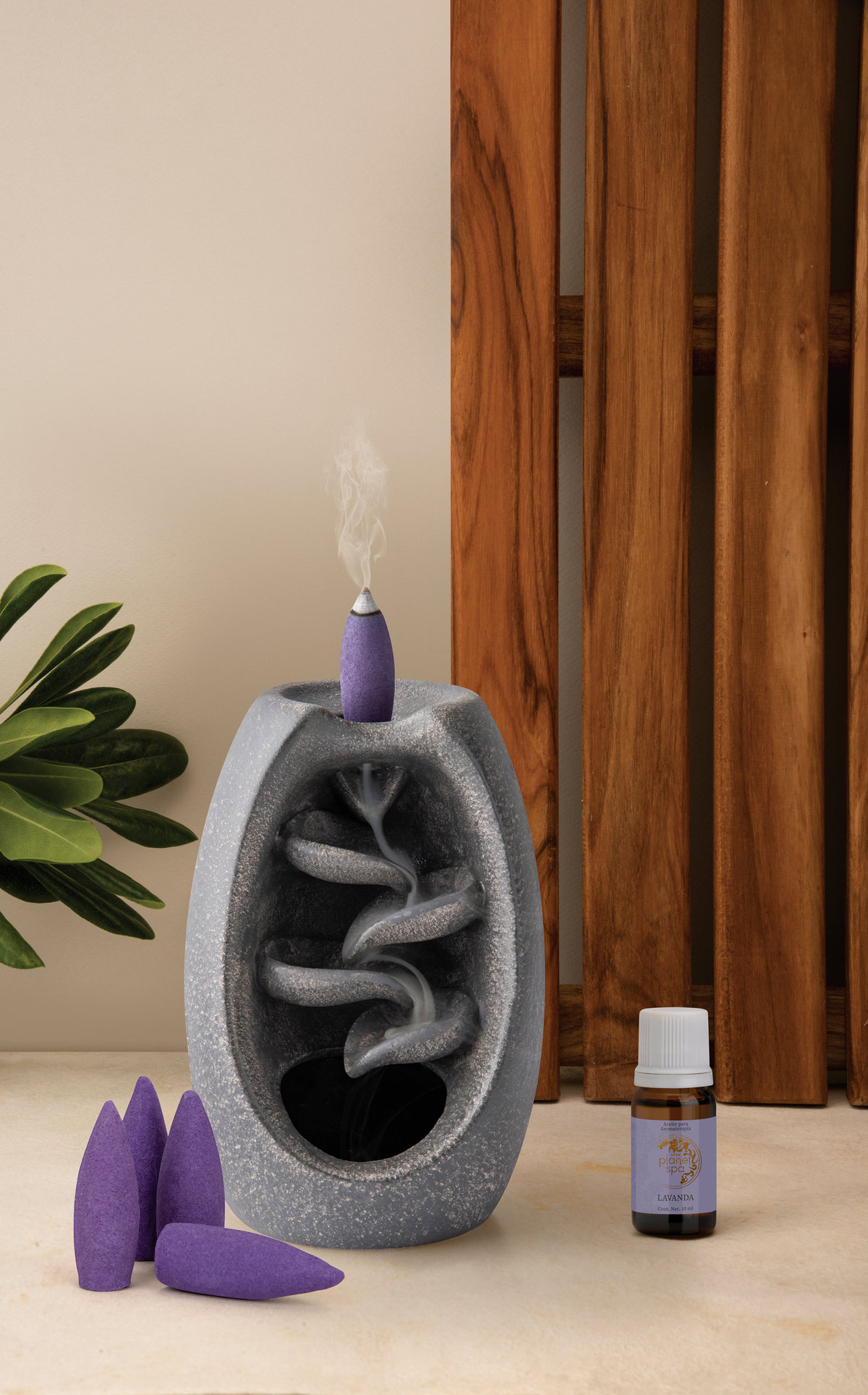 Backflow incense burner with purple cones and smoke