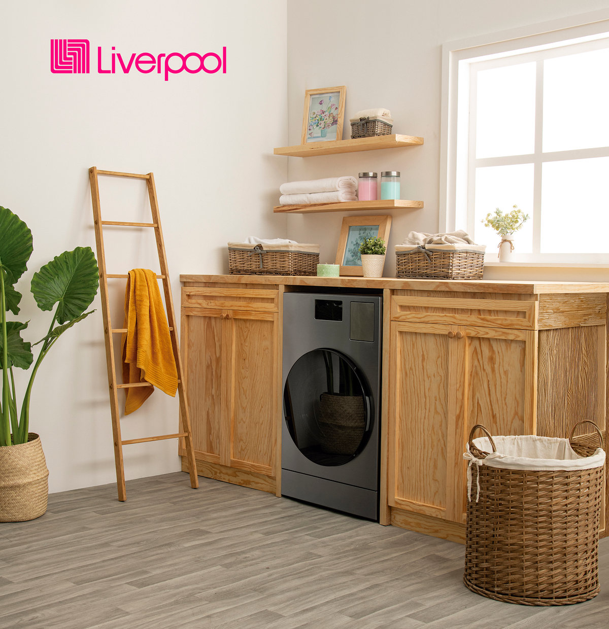 Laundry room with a washing machine, wooden cabinets and baskets, with the Liverpool logo