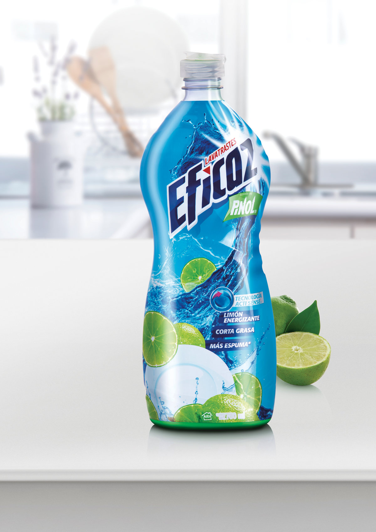 Bottle of cleaner with limes in a white kitchen