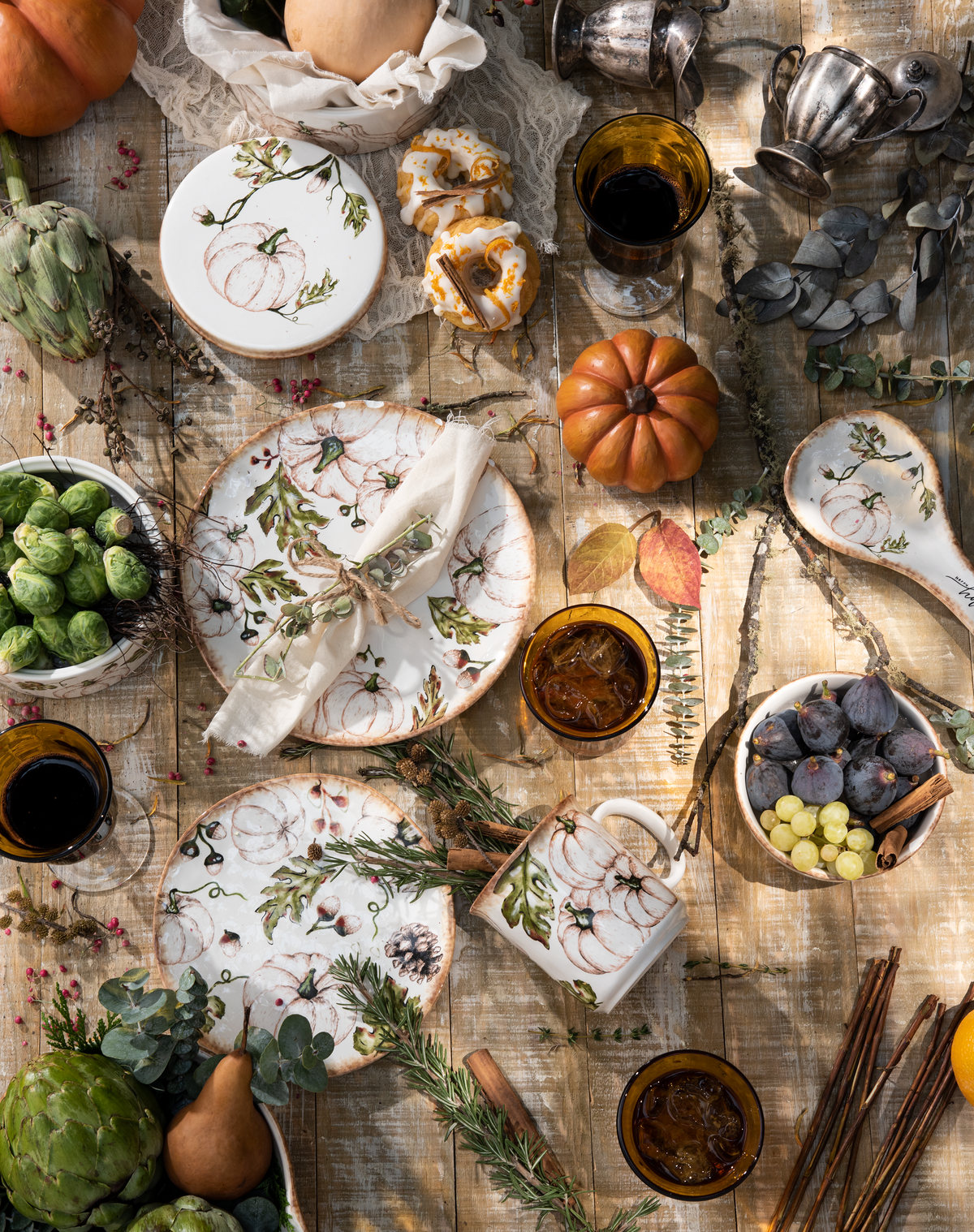 Autumn table seen from above with dishes, pumpkins, fruit and spices