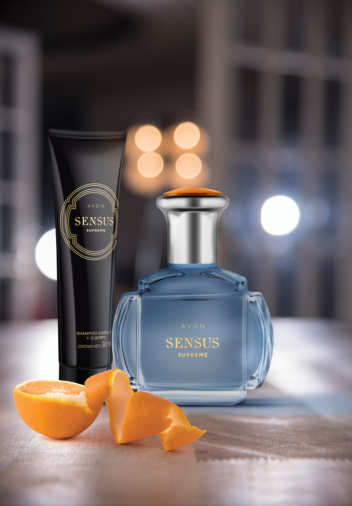 Blue Sensus fragrance bottle and black tube with orange peel and out-of-focus lights