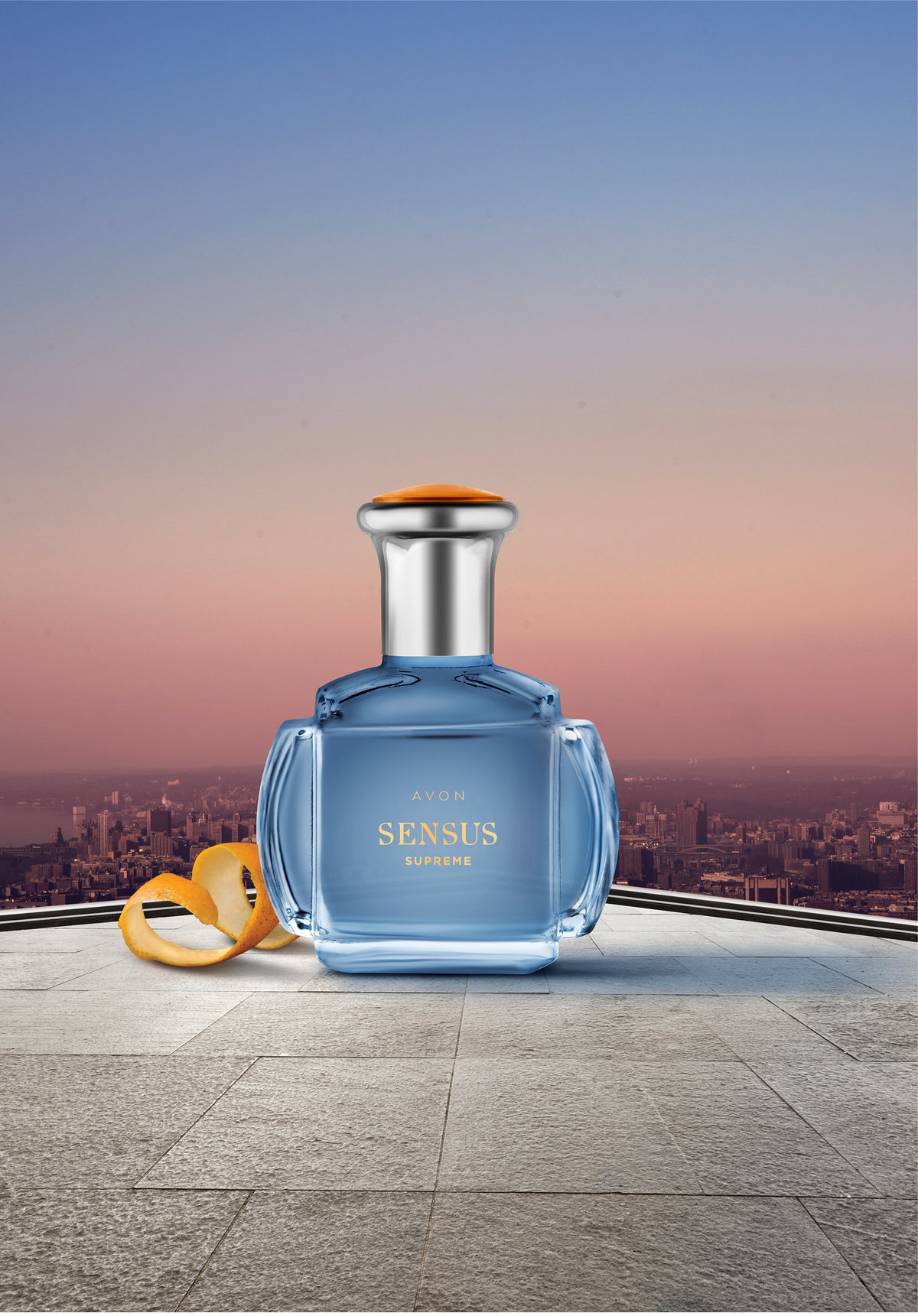 Sensus fragrance bottle on a terrace with the city at dusk behind it
